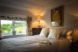 King size bed with views across garden and fields